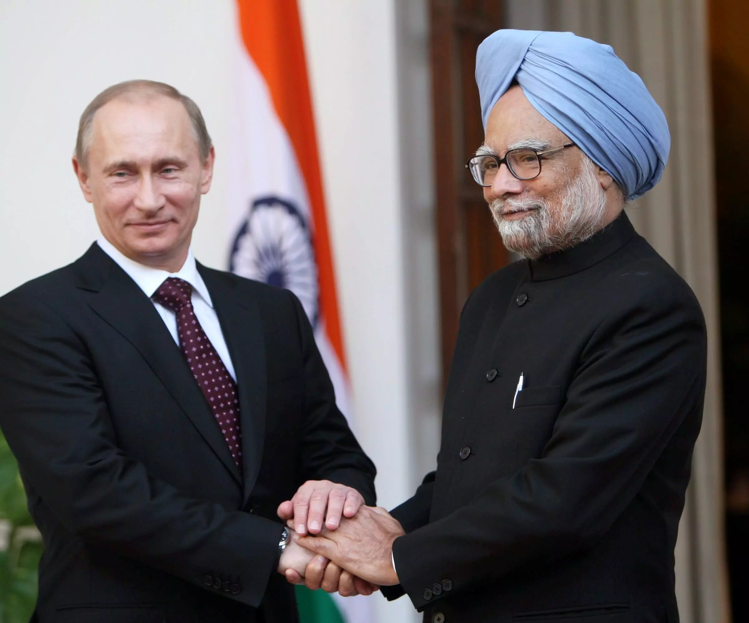 In this March 12, 2010 file image, Prime Minister Manmohan Singh shakes hands with his Russian counterpart Vladimir V Putin at a meeting at Hyderabad House in New Delhi. PTI