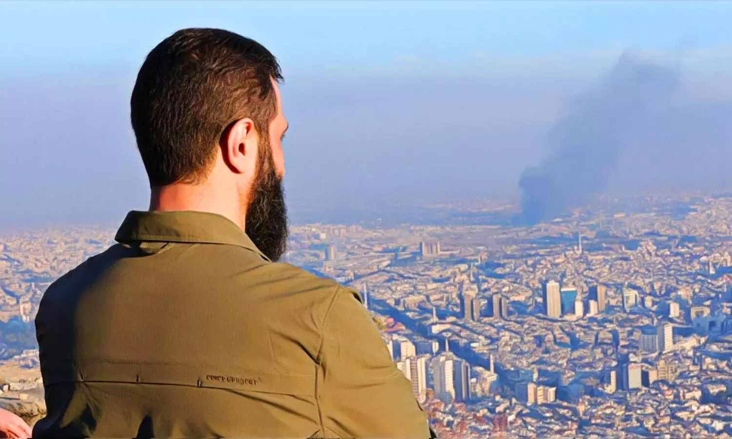 HTS leader Ahmad al-Shara, also known as Abu Muhammad al-Golani, looks out over Damascus, Syria, following the fall of Bashar al-Assad