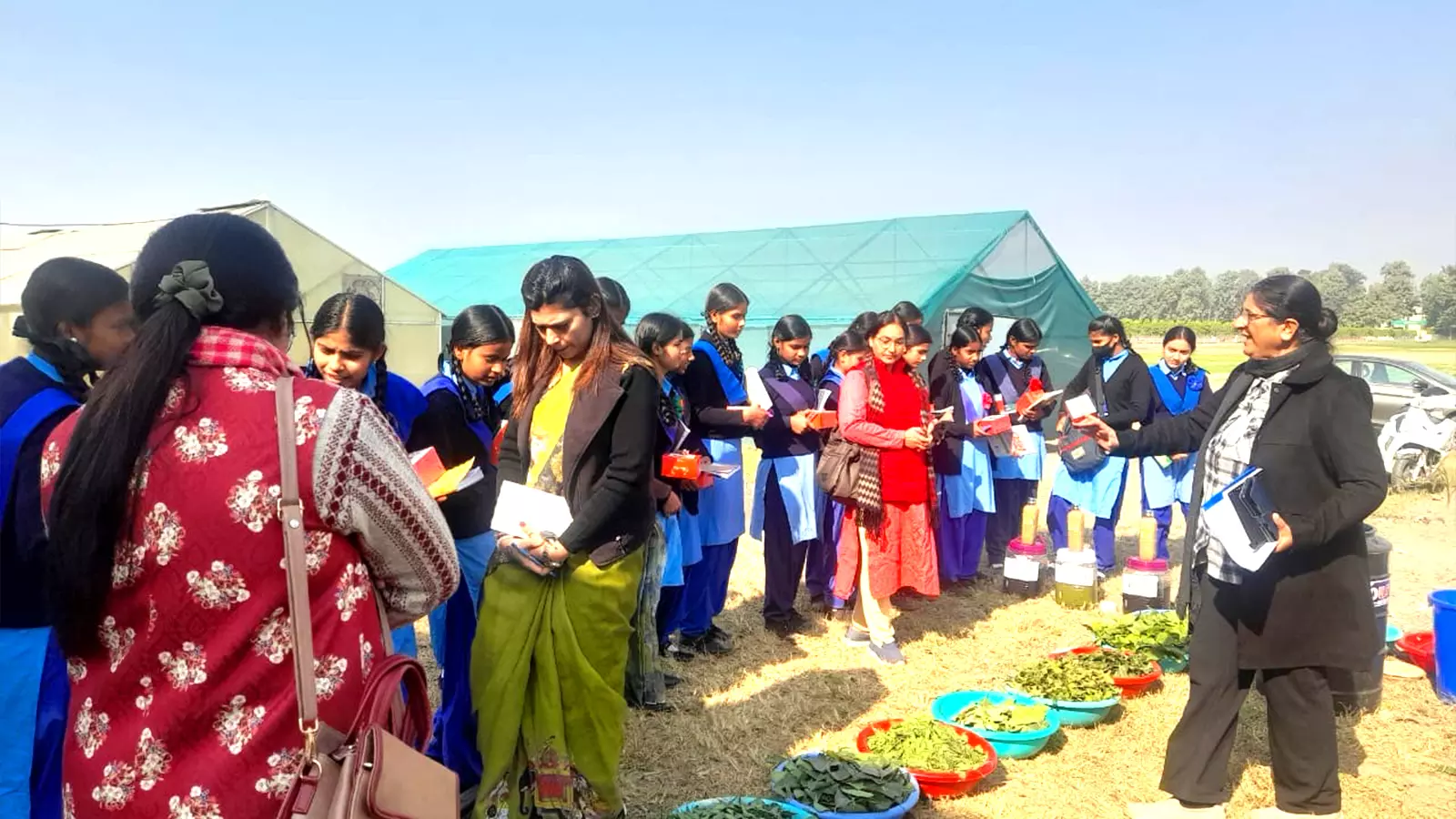 Sunita Pandy (right) shows traditional method in farming to students.