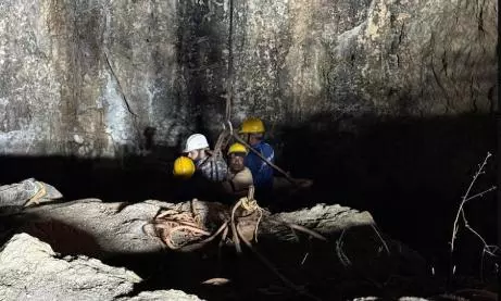 Rescuers enter the well of the mine in Assam