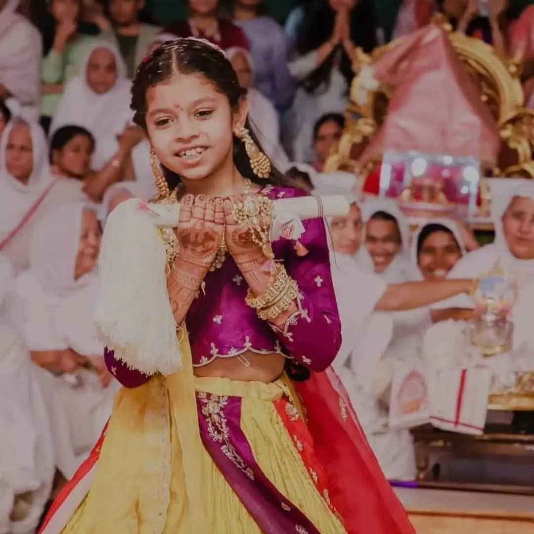 Devangshi on the day of her bal diksha with arohan, the white broom in her hand symbolising initiation into monkhood.