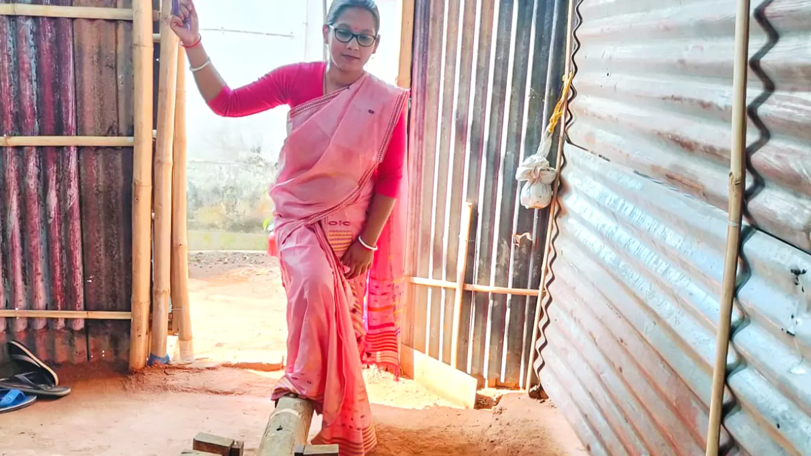 Bondita Chakravarty uses her right foot to pound rice in the dheki.