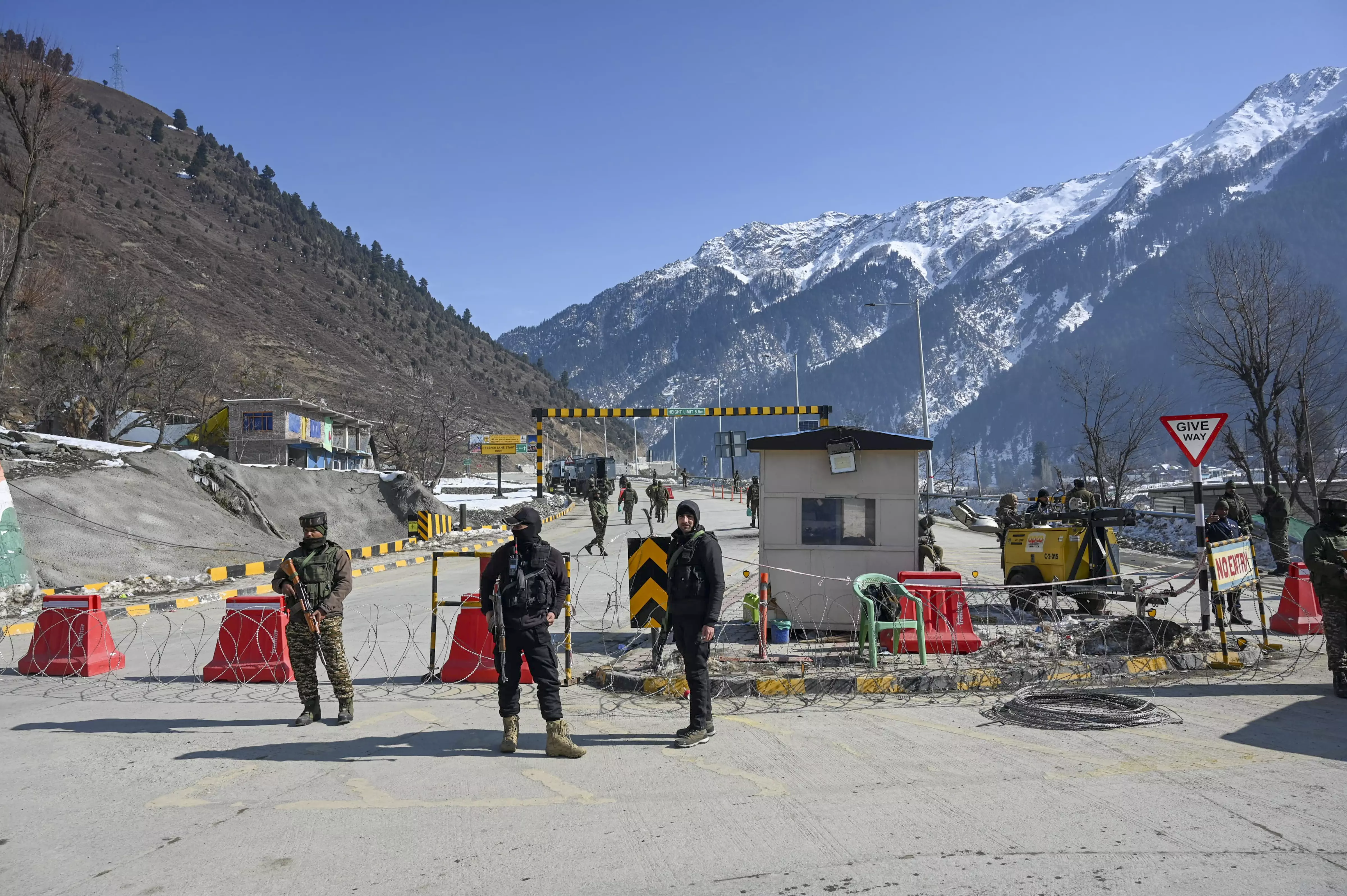 Security personnel stand guard near the tunnel project site. Photo: PTI