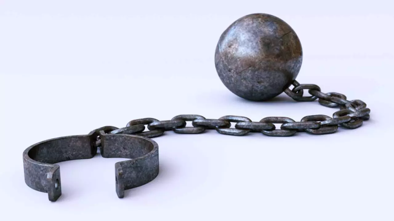 A white background with a metal shackle attached to a heavy metal ball with chains