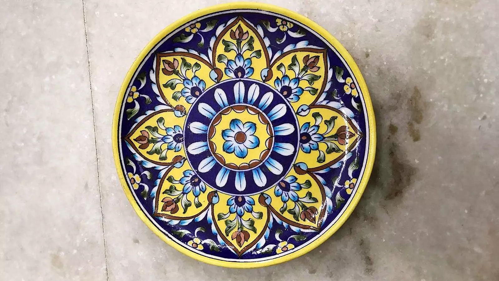 The signature colours of blue pottery come from distinct metal oxides: cobalt oxide produces deep blue, copper oxide creates light blue, chrome oxide results in green, cadmium oxide yields bright yellow, and ferro colours generate shades of brown.