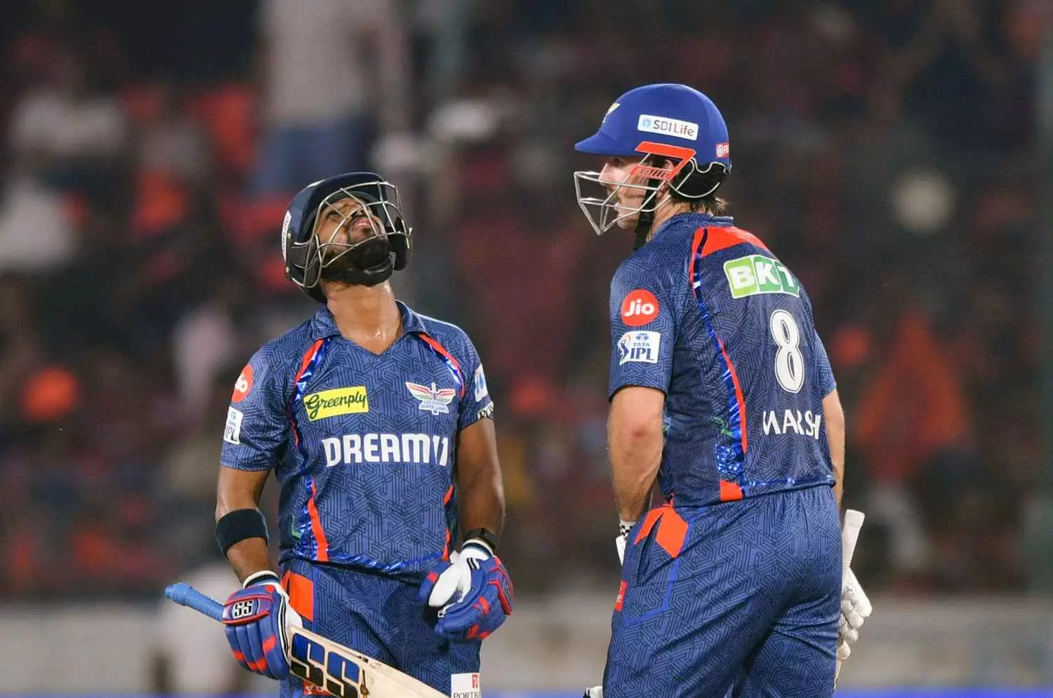 Lucknow Super Giants Nicholas Pooran, left, celebrates his half century with Mitchell Marsh