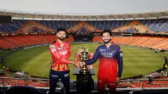Punjab Kings (PBKS) captain Shreyas Iyer (left) and Royal Challengers Bengaluru (RCB) skipper Rajat Patidar pose with the IPL trophy