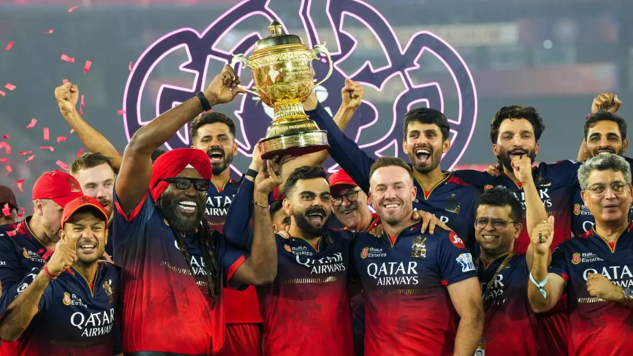 RCB players celebrate with the IPL 2025 trophy
