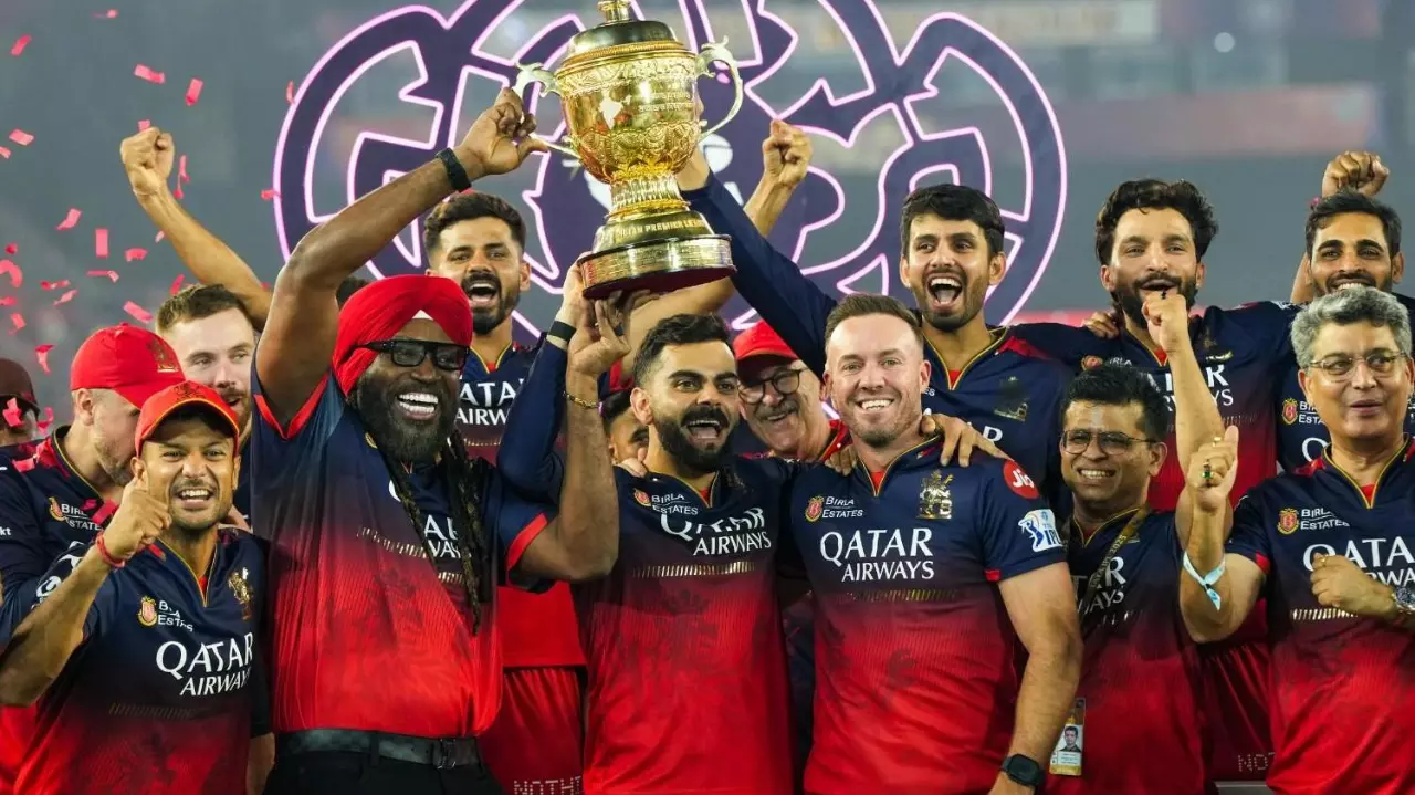 RCB players celebrate with the IPL 2025 trophy