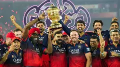 RCB players celebrate with the IPL 2025 trophy