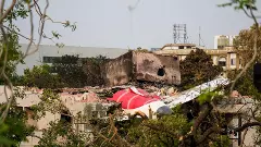 Remains of the crashed Air India plane lie on a building, in Ahmedabad, Saturday.