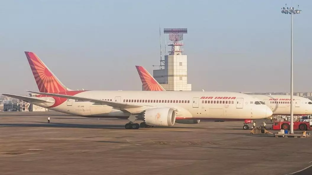 An Air India airlines plane is parked in the airport area