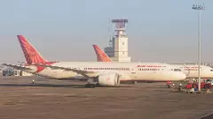 An Air India airlines plane is parked in the airport area An Air India airlines plane is parked in the airport area