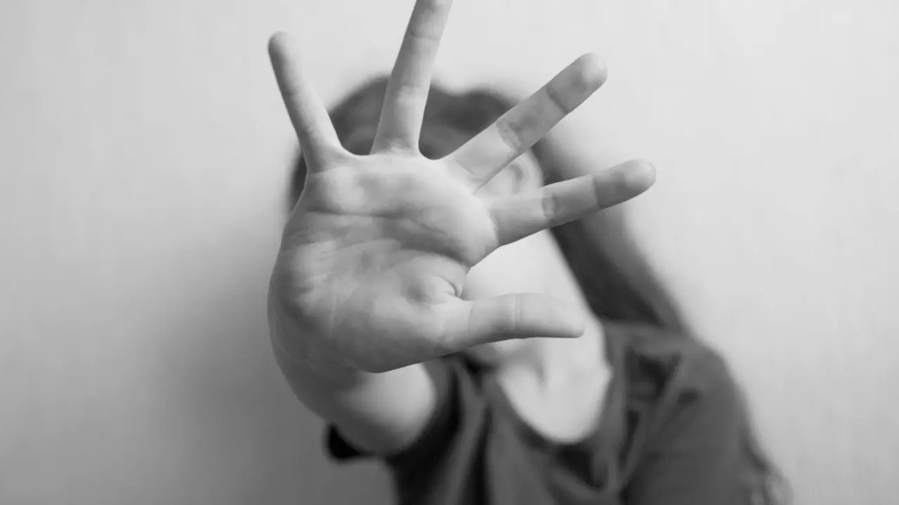 Little girl protects herself with an open palm
