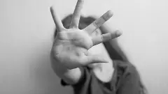 Little girl protects herself with an open palm