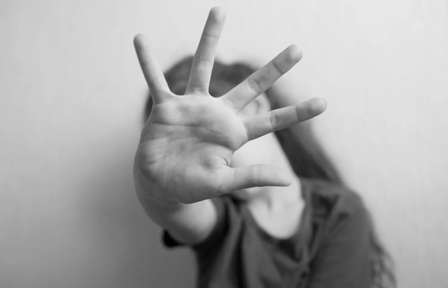 Little girl protects herself with an open palm Little girl protects herself with an open palm