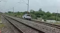Car being drive on railway tracks