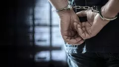 Criminal wearing handcuffs in prison