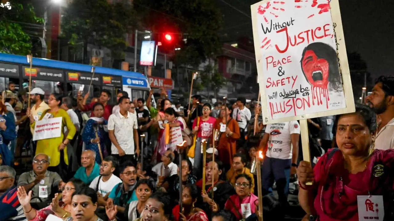 People raise slogans during a torch rally to protest against the alleged gangrape of a law student in her college in Kolkata