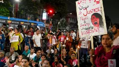People raise slogans during a torch rally to protest against the alleged gangrape of a law student in her college in Kolkata