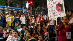 People raise slogans during a torch rally to protest against the alleged gangrape of a law student in her college in Kolkata
