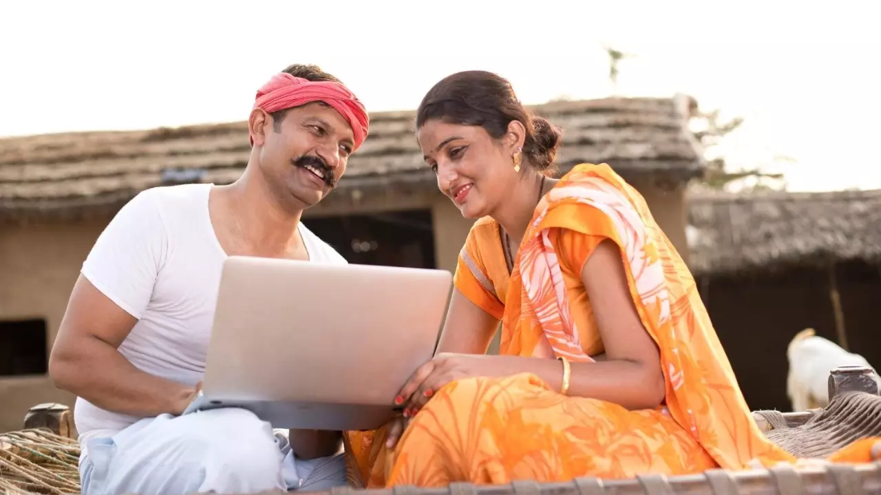 Kalaa Setu Indian couple using laptop at village