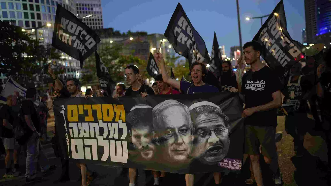 People take part in a protest demanding the end of the war and immediate release of hostages held by Hamas in the Gaza Strip