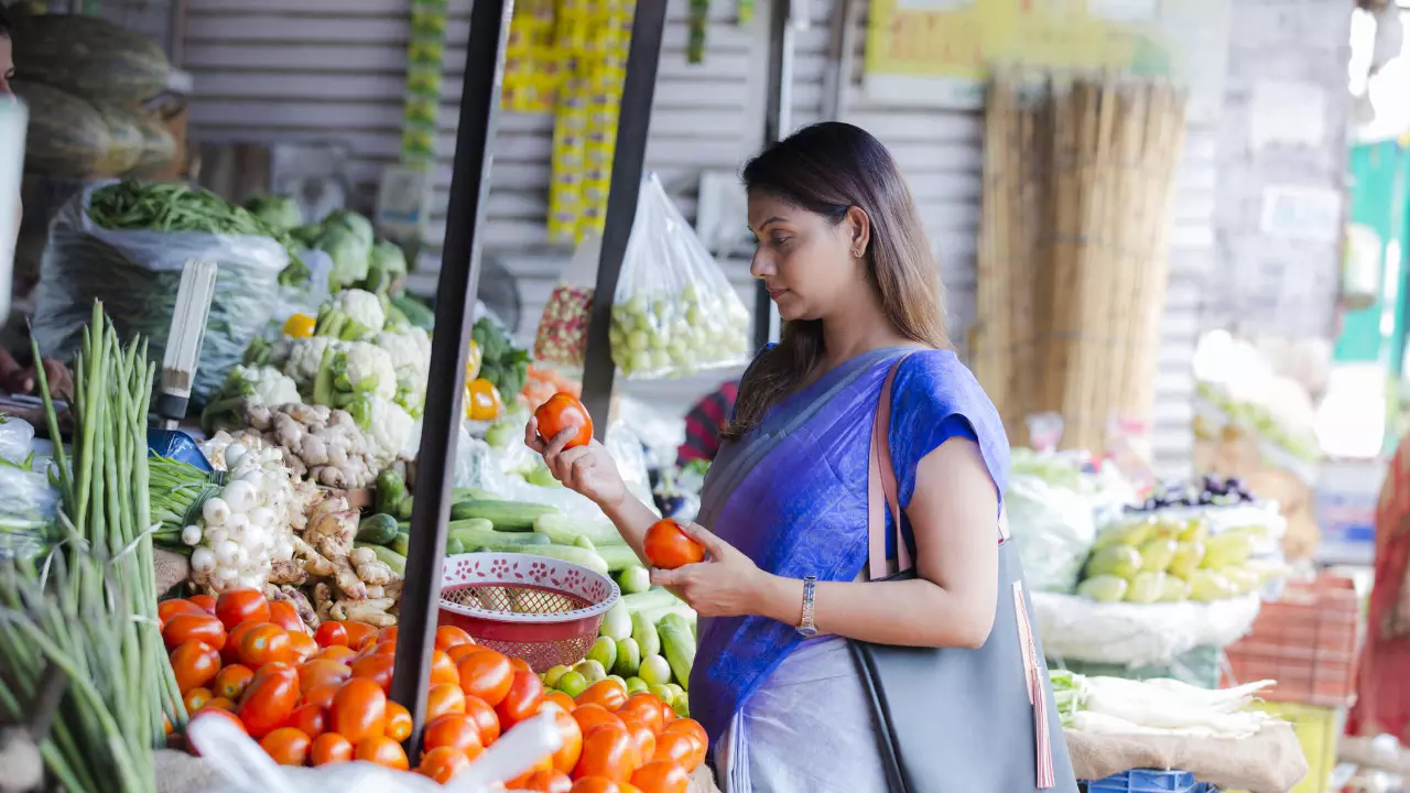 Woman buying vegetables at a street vendor