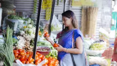 Woman buying vegetables at a street vendor
