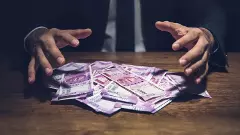 Businessman taking pile of money