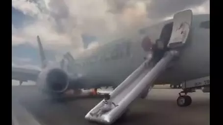 Chaos at Denver airport: Passengers evacuate American Airlines jet as smoke fills runway Chaos at Denver airport: Passengers evacuate American Airlines jet as smoke fills runway