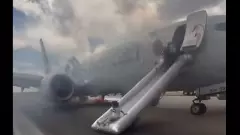 Chaos at Denver airport: Passengers evacuate American Airlines jet as smoke fills runway