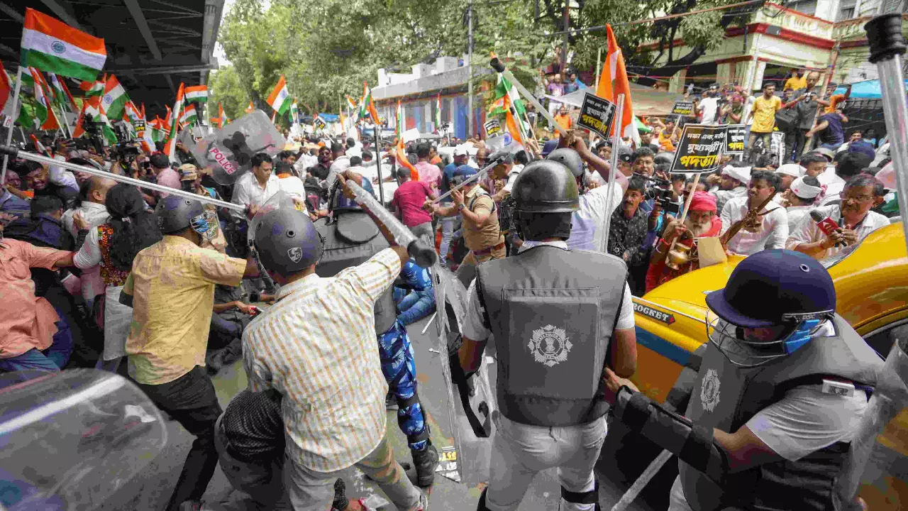 BJP members and security personnel clash during a protest BJP members and security personnel clash during a protest