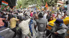 BJP members and security personnel clash during a protest