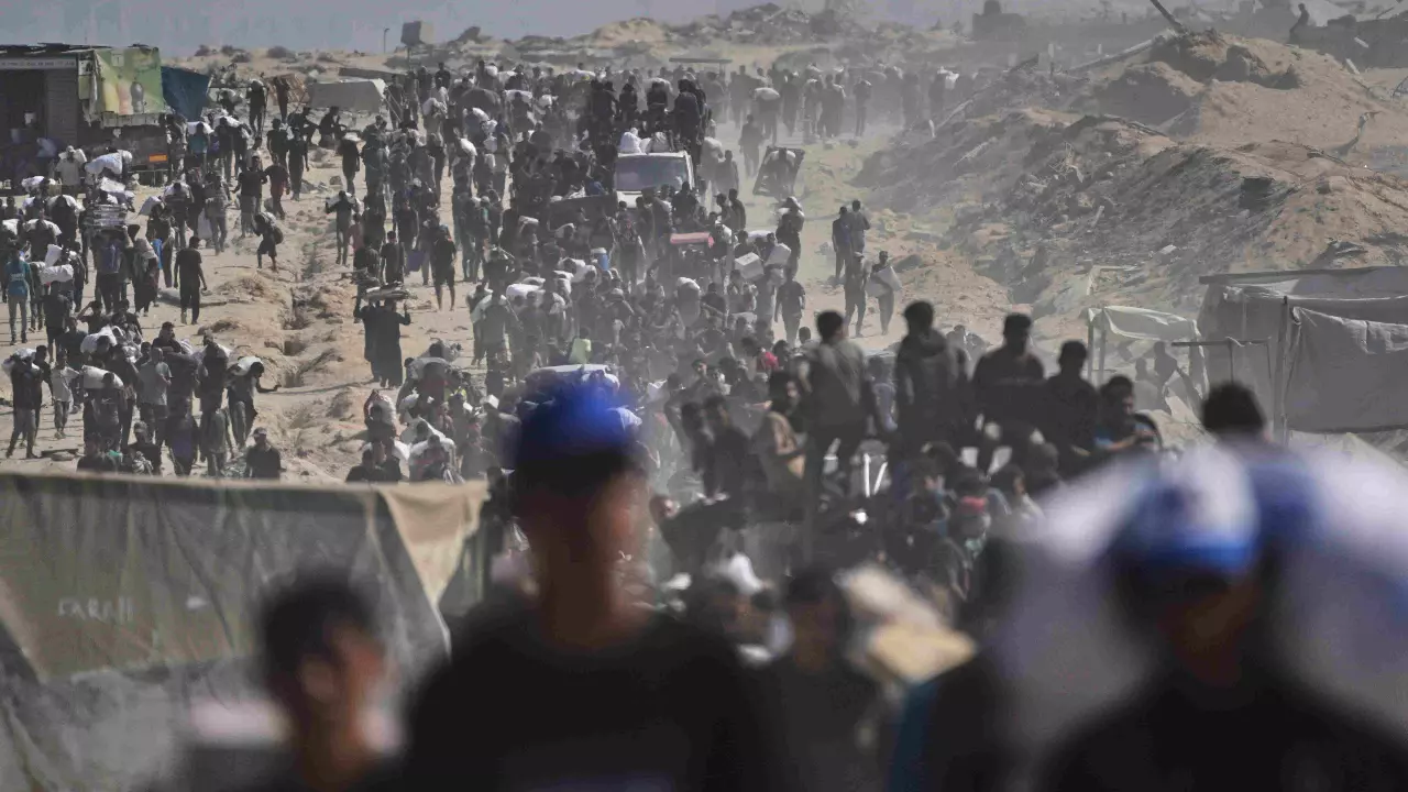 Palestinians carry sacks of flour unloaded from a humanitarian aid convoy