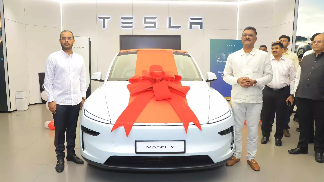 Maharashtra Transport Minister Pratap Sarnaik (right) with his Tesla Model Y