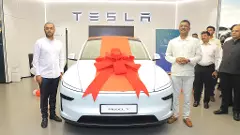 Maharashtra Transport Minister Pratap Sarnaik (right) with his Tesla Model Y
