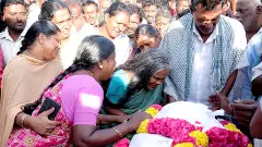 Bereaved relatives mourn the victim of a stampede at Karur