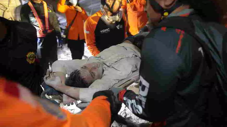 65 buried in Indonesia school building collapse; rescuers run oxygen to survivors