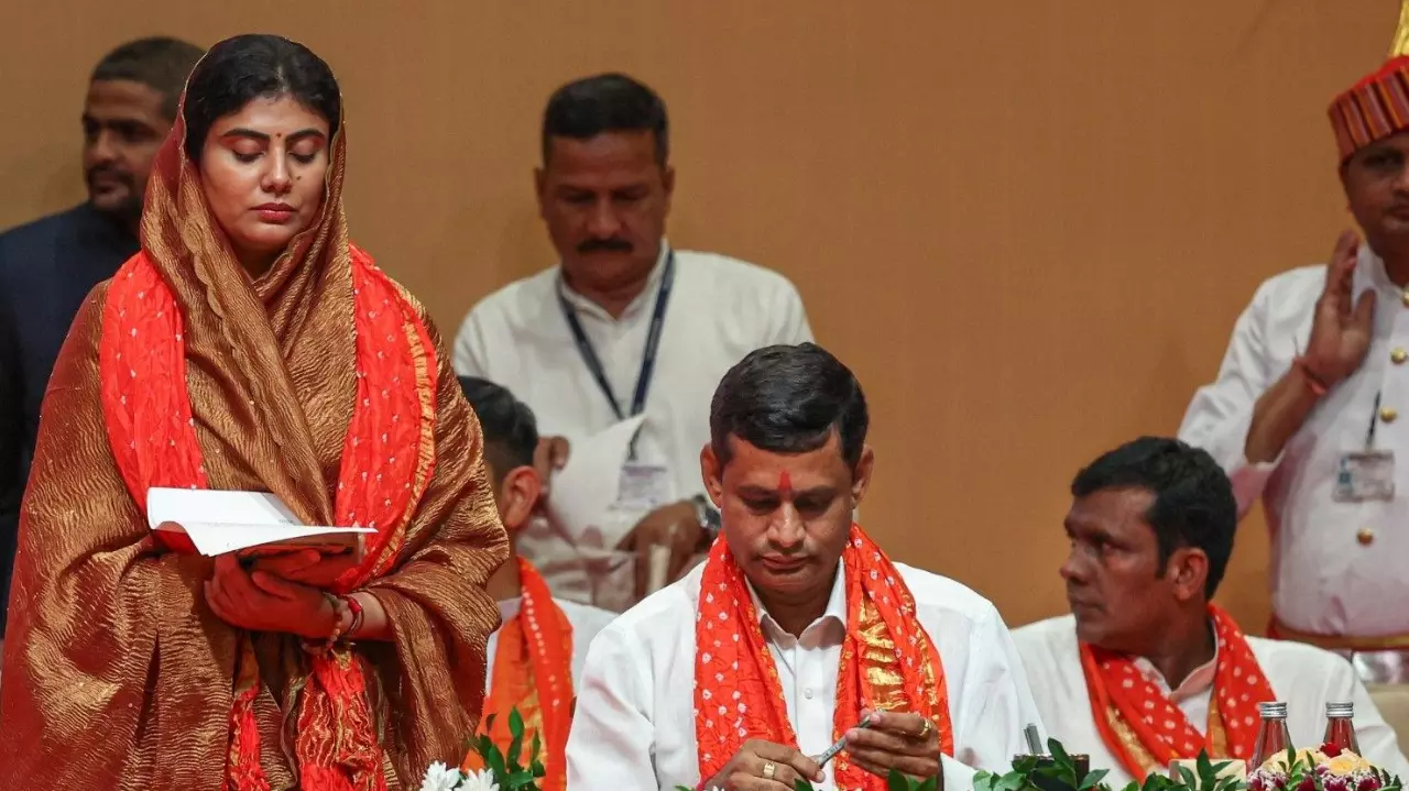 Rivaba Jadeja, wife of cricketer Ravindra Jadeja, and other BJP MLAs take oath during the swearing-in ceremony of the new Gujarat cabinet, in Gandhinagar