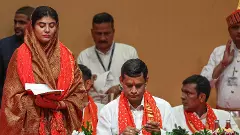 Rivaba Jadeja, wife of cricketer Ravindra Jadeja, and other BJP MLAs take oath during the swearing-in ceremony of the new Gujarat cabinet, in Gandhinagar