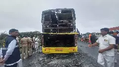 Officials inspect the charred bus at the accident site