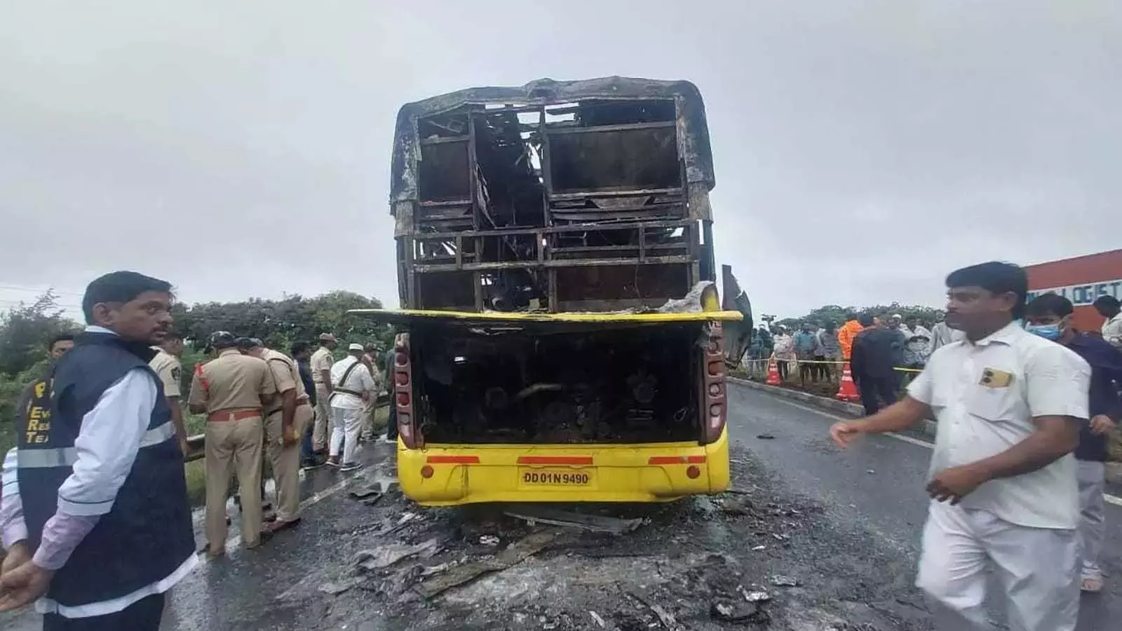 Officials inspect the charred bus at the accident site Officials inspect the charred bus at the accident site