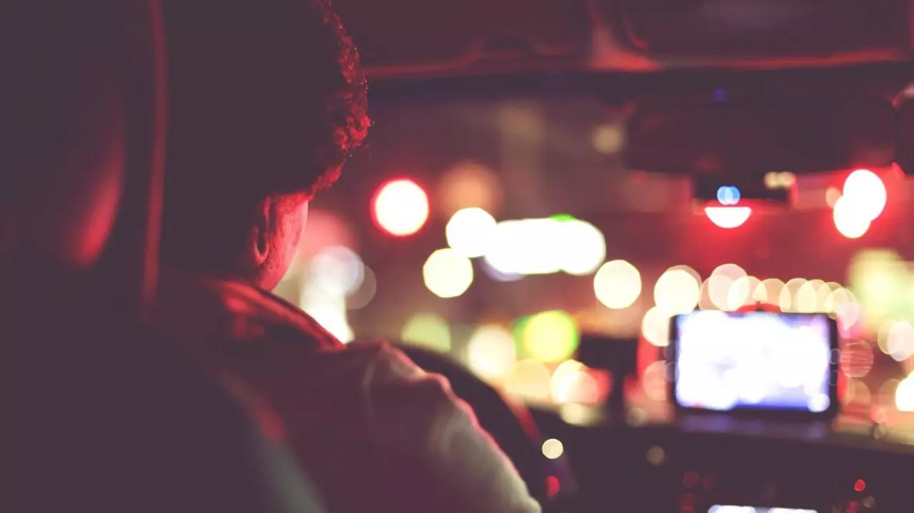 Rear View Of Man Driving Car At Night stock photo
