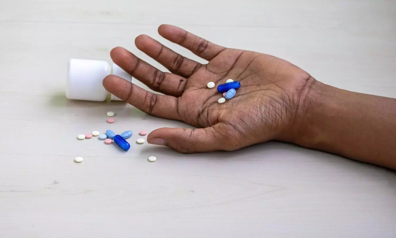 Mans hand with various tablets and pills Mans hand with various tablets and pills