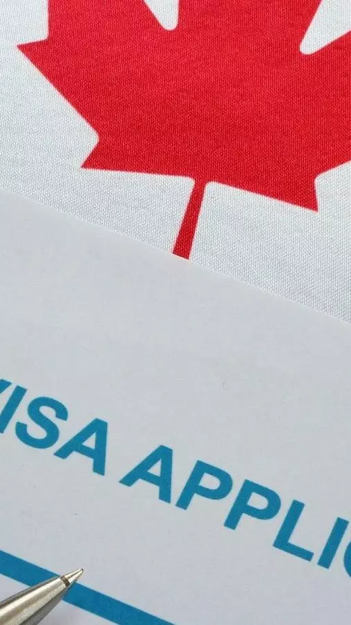 visa application form and Canada flag