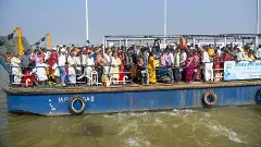 Voters onboard a ferry to cross the Ganga river before casting their votes during the first phase of the Bihar Assembly elections, at Danapur in Patna