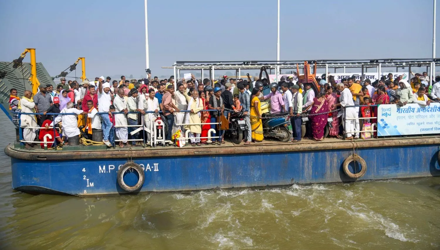 Voters onboard a ferry to cross the Ganga river before casting their votes during the first phase of the Bihar Assembly elections, at Danapur in Patna Voters onboard a ferry to cross the Ganga river before casting their votes during the first phase of the Bihar Assembly elections, at Danapur in Patna