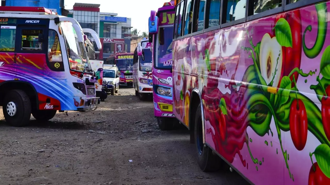 Lots of colorful typical Indian buses at bus station in Tamil Nadu