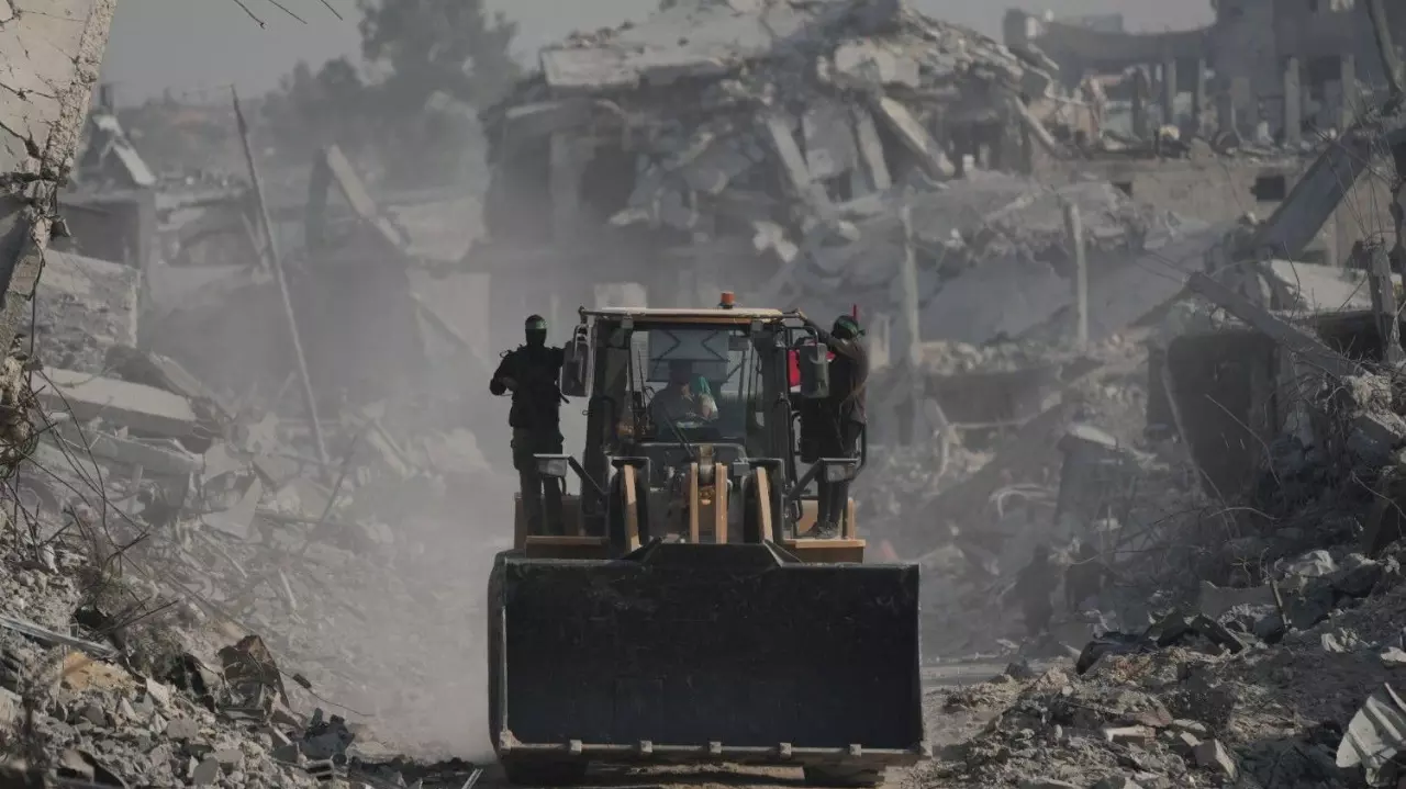 Hamas militants and Egyptian workers search for the bodies of Israeli hostages in Gaza